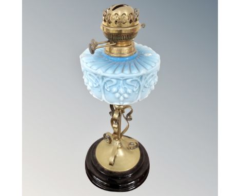 A Victorian oil lamp with blue glass reservoir.