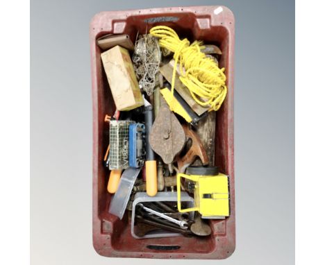 A plastic crate containing tools, lamps, spanners, rope etc.