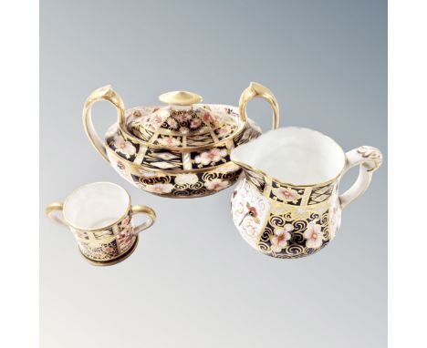 Three pieces of Royal Crown Derby china including miniature twin handled jug, lidded sugar basin and a milk jug.