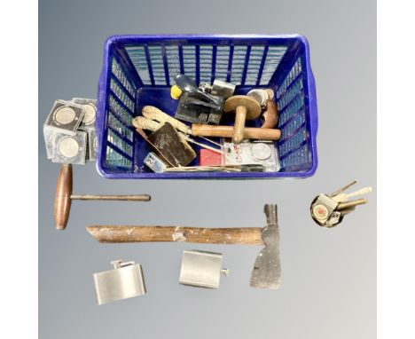 A crate containing commemorative coins, a vintage axe, hip flask etc.