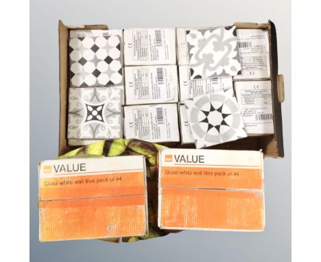 A box containing ceramic tiles, boxes of gloss white wool tiles etc.