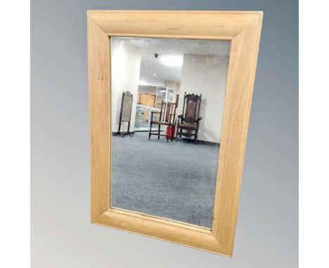 A light oak framed mirror.