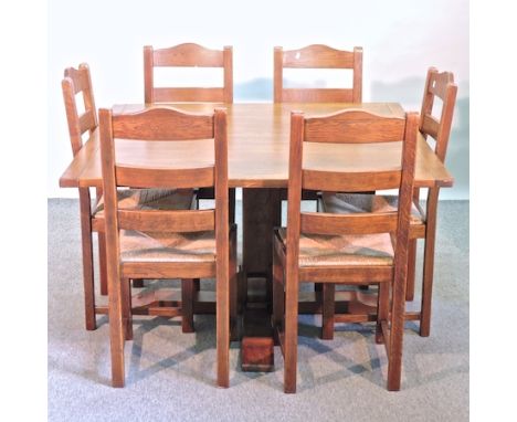 A modern oak extending dining table, 180 x 130cm together with a set of six ladder back dining chairs