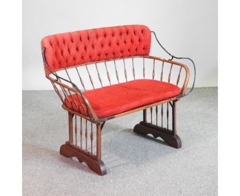 An early 20th century spindle back and red upholstered sofa, converted from a horse buggy, 102cm