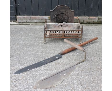 A cast iron fire back, together with a fire basket, 66cm and a various thatcher's tools