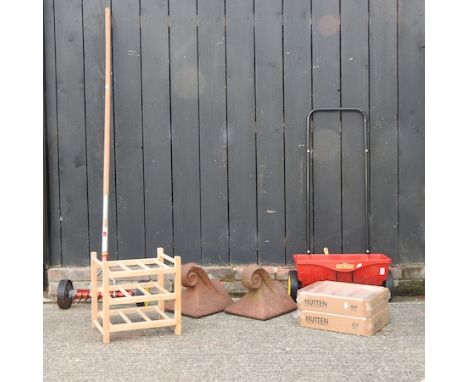 A terracotta ridge tile, together with another, wine racks, 32cm, and garden tools