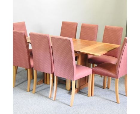 A 20th century light oak draw leaf dining table, 106 x 75cm (closed), together with a set of eight red upholstered dining cha