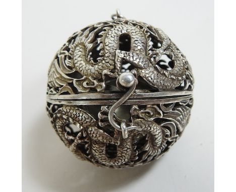 A Chinese white metal pierced censer, in the form of a hinged ball, 5cm diameter, on a chain