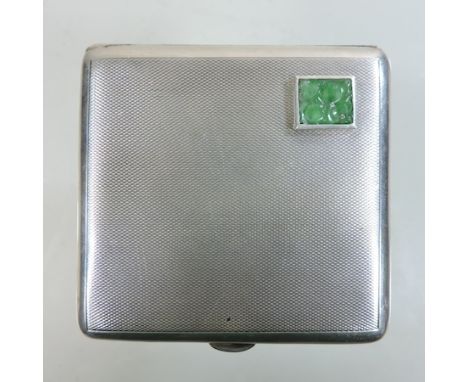 An early 20th century silver cigarette case, with a diamond set jade inset panel, Birmingham 1935, 8cm