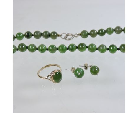 A green jade coloured suite of jewellery, to include a necklace, a pair of earrings and a 9 carat gold ring (4)