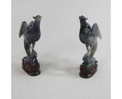 A pair of jade coloured carvings of birds, 16cm high