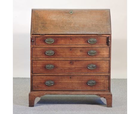 A George III oak bureau, on bracket feet, 92cm