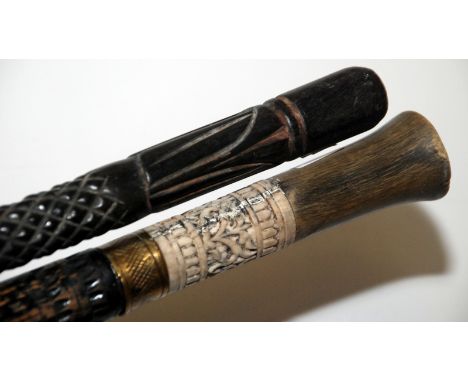 An Indian swordstick and a carved ebony walking stick.