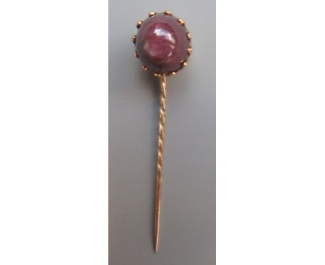 A gold mounted star ruby stick pin.