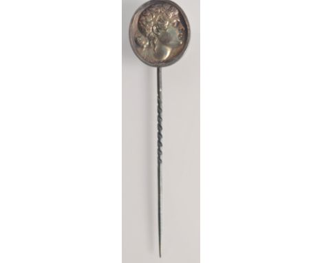 A 19th century silver pin the finial with an intaglio portrait of Apollo.