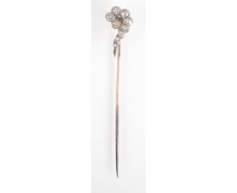 A white and yellow gold pin, the finial with a scroll of brilliant cut diamonds, red leather covered case of Alfred Taylor, T