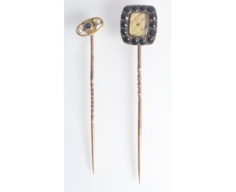 A gold pin with diagonal oval finial set with a central sapphire flanked by pearls together with a gold mourning pin, each bo