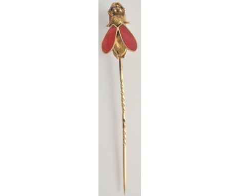 A good Victorian gold pin the fly finial with garnet eyes and enamel wings.