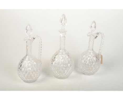 A pair of Victorian cut glass claret jugs and a matching decanter.