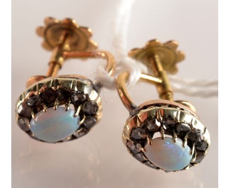 A pair of diamond and opal oval cluster screw on earrings.