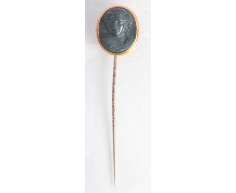 A Victorian gold stick pin with a large bloodstone cameo carved finial.