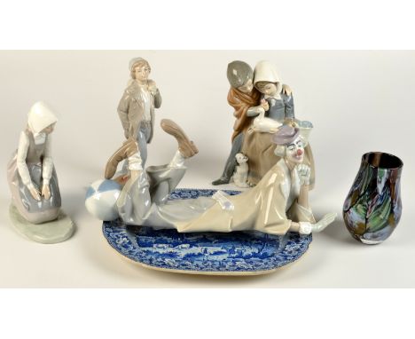 A Lladro large model of a clown lying down, a ball at his feet, length 38cm, together with three Nao figures and a blue and w