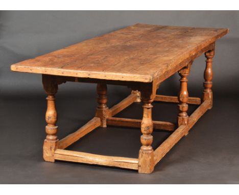 A fine 17th century 'with alterations' light oak refectory table, the substantial top of three pleated planks, the frieze wit