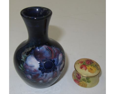 A Worcester ivory ground floral painted pomade pot and a small Moorcroft vase.