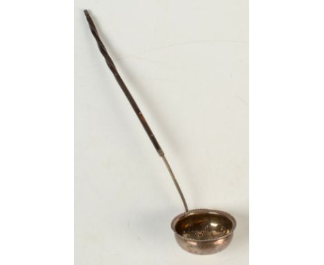 A George III silver punch ladle, the interior embossed with a star, at the centre of this a gold 1/3 guinea dated 1804.