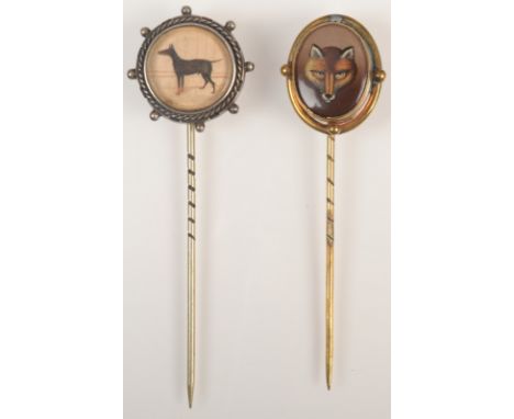 A silver stick pin, the finial set a miniature painting of a doberman in a stable together with a gilt pin with an enamelled 