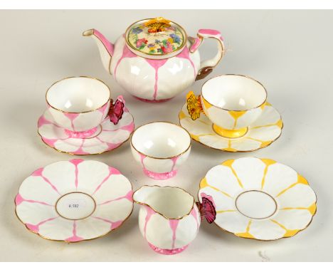 Two Aynsley teacups each with butterfly handle, one pink, the other yellow and each with a matching saucer, together with a m