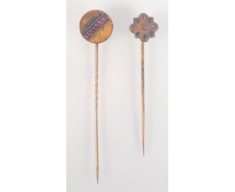 A gold pin, the plain lobed flowerhead finial set with nine tiny cabouchon rubies and a late Victorian gold pin, the finial w