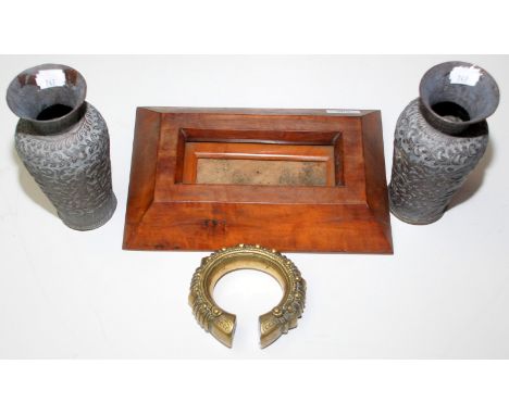 A small frame, a pair of Indian chased copper vases and a heavy African brass bangle.