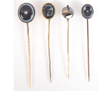 Three banded agate stick pins, one set with a diamond, together with a Victorian gold stick pin, set with various stones and 