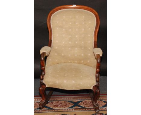 A Victorian mahogany spoon back gentleman's armchair, the button upholstered back and padded seat on cabriole supports with l