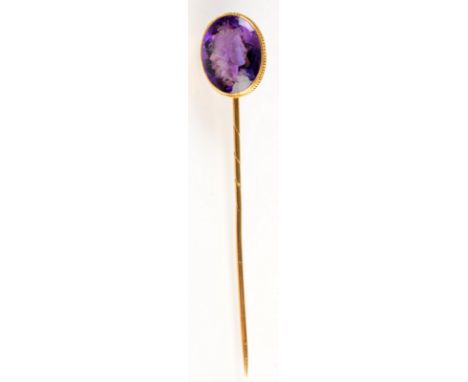 A 18ct. gold stick pin, the finial, an intaglio carved amethyst.