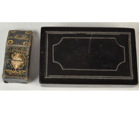 A papier mache snuff box and a gilt tooled leather needle case.