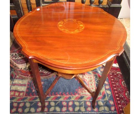 A Edwardian circular, inlaid table on square section legs joined by a low shelf, diameter 68cm.