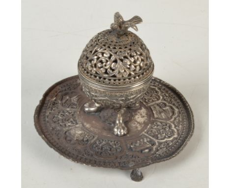 A good Indian silver 19th century ink stand, the near spherical holder with bird finial on three legs, the tray base decorate