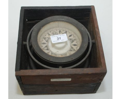 A ship's brass compass on a gimbal mount, now mounted in a hardwood box, bears label 'Salvaged off Enid, near Carn Boscawen 3