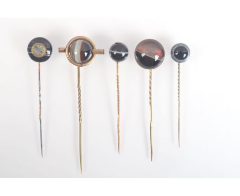 A banded agate pin set a miniature compass together with four other banded agate pins.
