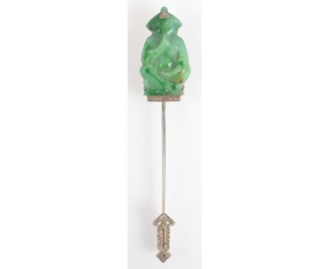 A 1920s French Jabot pin in white gold with a carved jade seated figure finial set with rose cut diamonds, the sliding clip s