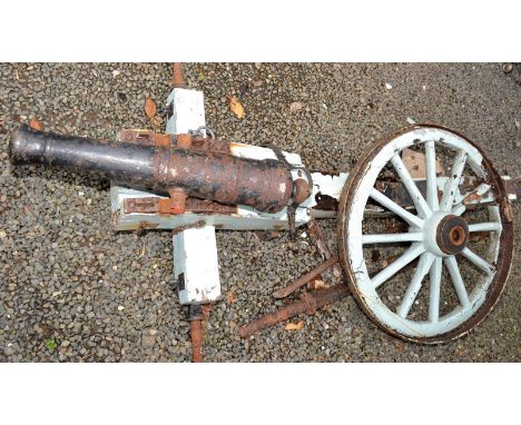 An early/mid 19th century iron 5cm. bore cannon, length 78cm, on a wooden field carriage, one iron rimmed spoked wheel surviv