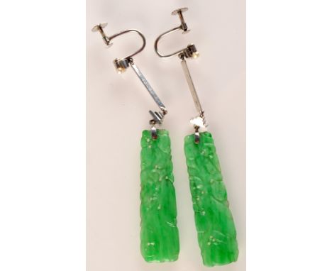 A pair of good Art Deco 9 ct. white gold Chinese jade earrings, each slightly tapering jade panel carved and pierced with fol