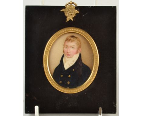 A fine George III miniature portrait of a young gentleman wearing a blue coat, his short hair in the Regency taste, 6.5 x 5cm