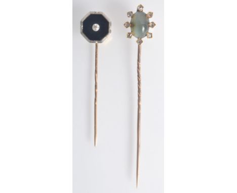 A gold stick pin set with cat's eye surrounded by eight rose cut diamonds, together with one other diamond set pin.