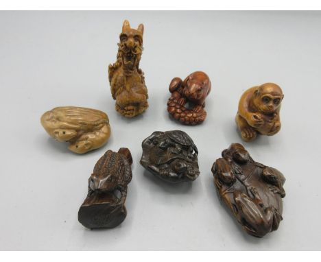 Japanese carved hardwood netsuke in the form of four frogs on a lily pad, L5.5cm and six other carved netsukes