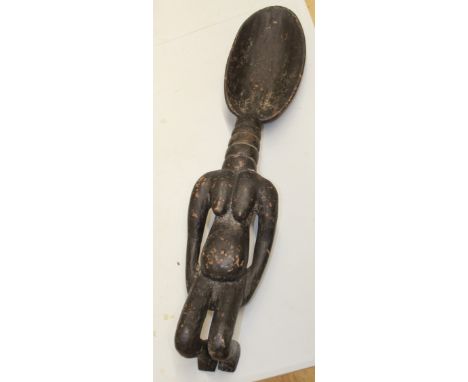 Large carved wooden ceremonial fertility ladle, likely originating from the Dan peoples, with age-related wear to extremities