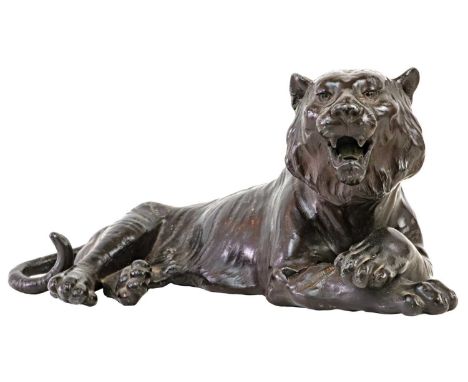 A Chinese bronzed model of a tiger. Seal mark, height 11cm, length 25.5cm.