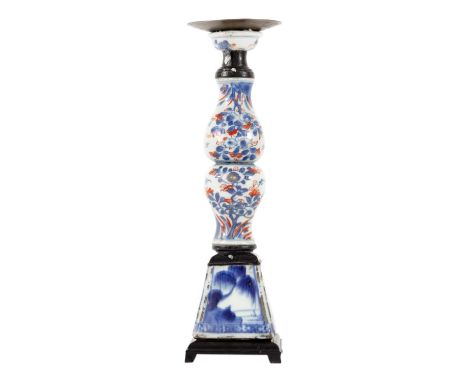 A Chinese porcelain candlestick, 18th century. With wooden mounts, height 28cm, width 7.5cm.hairlines, chips and fritting.